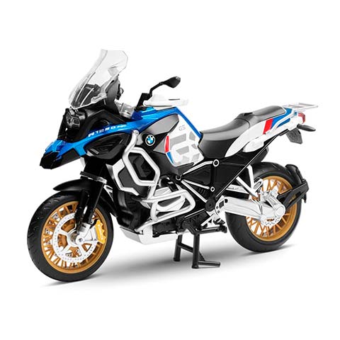 Blue, white, and black BMW adventure motorcycle with gold wheels on a white background.
