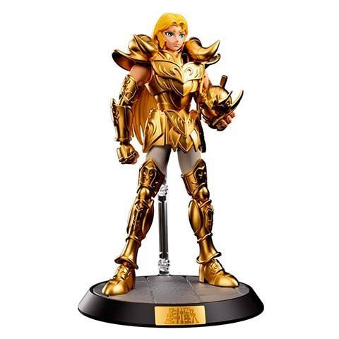Gold-armored action figure standing on a black display base on show.