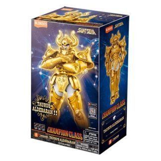 Boxed Saint Seiya Taurus Aldebaran Champion Class action figure with gold armor on a blue starry background, packaging showing the figure on the front and side panels.