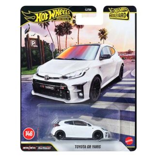 White Toyota GR Yaris Hot Wheels Premium die-cast car in packaging, with Hot Wheels branding and a street scene background.