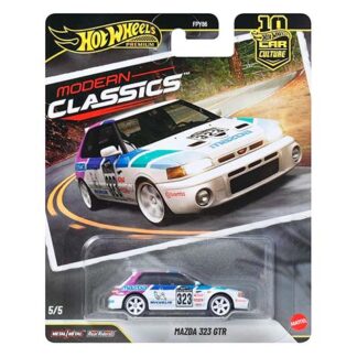 Hot Wheels Modern Classics packaging showing a white Mazda 323 GTR with blue-teal racing stripes, in a blister on a race track background.