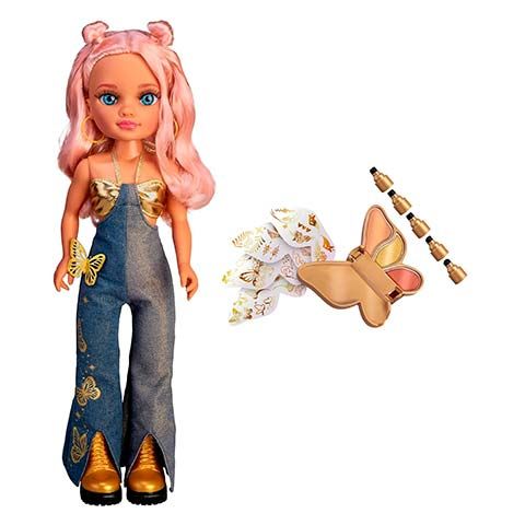 Doll with pink hair and blue eyes wearing denim overalls with gold accents; butterfly decorations on the pants and shoes, accessories nearby.