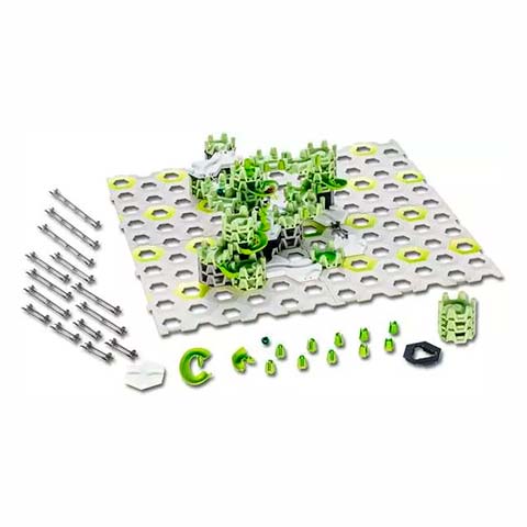 Assorted construction toy pieces on a perforated base plate, with green connectors, metal rods, and small pins arranged for assembly.
