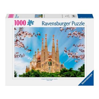 Ravensburger 1000-piece puzzle box featuring a photo of the Sagrada Família cathedral against a blue sky with surrounding greenery and pink blossoms.